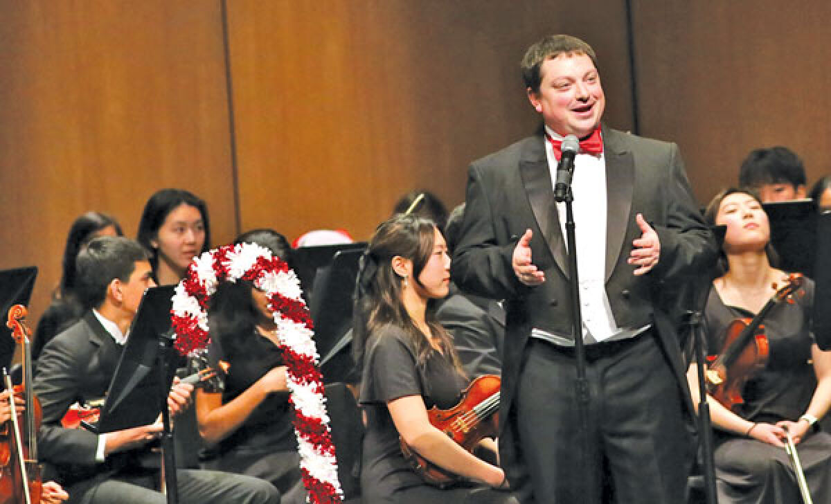  Jim Van Eizenga, Novi High School’s director of orchestras, leads his orchestra students during the recent holiday season. 