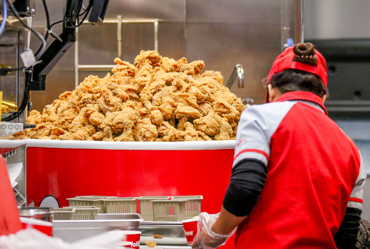  The new Sterling Heights Jollibee location’s kitchen demonstrates its fried chicken cooking capabilities during a Jan. 11 preview event. The restaurant’s official opening to the public is Jan. 12. 