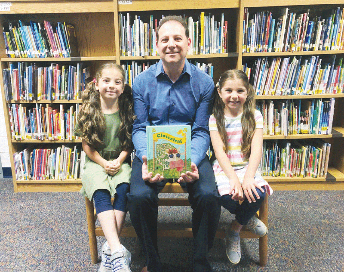  Pier Fazzalari displays the Cloverleaf reading anthology that he borrowed from the Dresden Elementary School library as a second grader in 1978 and forgot to return. Today, Fazzalari’s two daughters, Adrianna and Alexandria, attend Dresden Elementary School, and Fazzalari returned the book. 