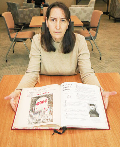  Roslyn Grafstein, mayor of Madison Heights, shares a book on the Holocaust by her  grandfather, Melech Grafstein. His brother,  Nusin Dovid Grafstein, died in Auschwitz.  During an event at the Madison Heights  Public Library Jan. 25, a panel will discuss  the importance of remembering the Holocaust. 