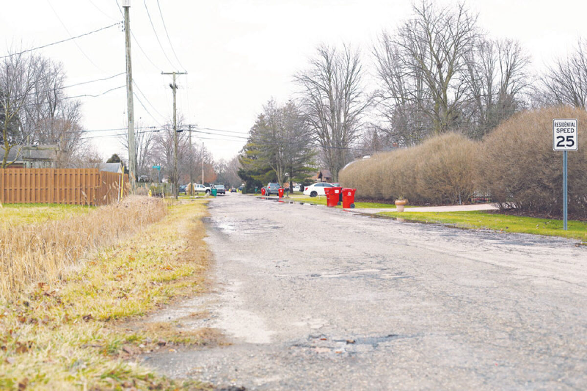  Cracks and potholes line North Blom Drive, which is the current target of a special assessment district campaign. The district would use funds raised by residents to pay for road repairs. 