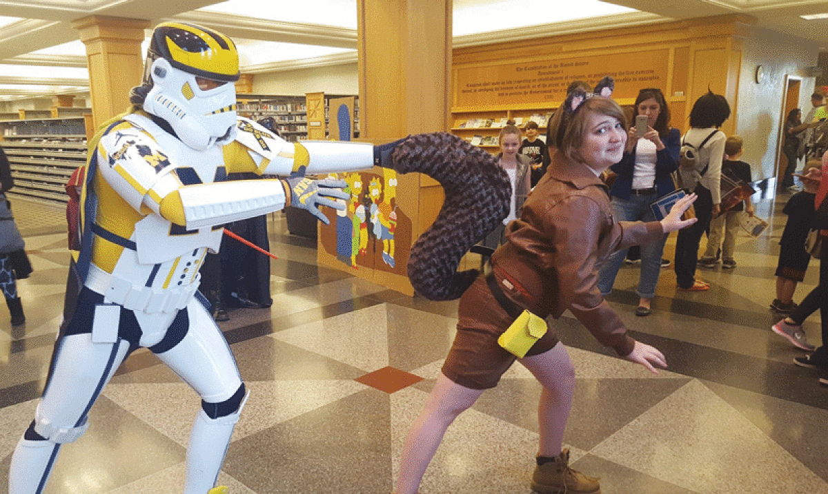  A member of the 501st Legion, a “Star Wars” fan group, poses with Shelby James dressed as Squirrel Girl at a prior Clinton-Macomb Public Library Comic Con.  