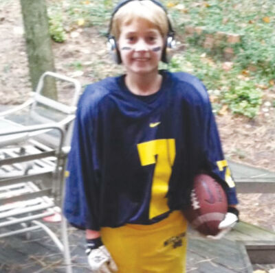  A young Howes reps his favorite football team — the University of Michigan. 