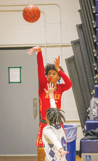  Troy Athens senior Brayden Downey attempts a shot from the corner during a matchup against Farmington Jan. 18 at Farmington High School. 