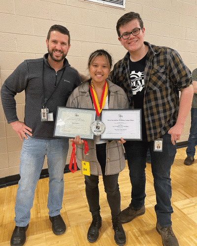  Instructors Jesse Siress, left, and Kallan Kriewall celebrate with Kayli Nguyen after she won her division at the Ferris State Secondary Welding Competition May 6. 