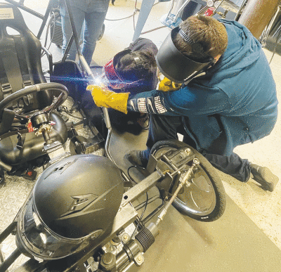  Kayli Nguyen, right, welds with her Stevenson High School Manufacturing, Automation and Design Engineering senior classmate Wes Melitz. Melitz placed third at the Ferris State competition in the combined process fabrication division. 