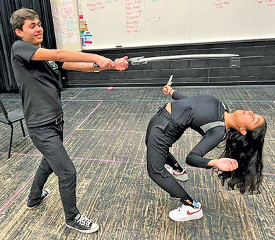  Students Milan Thurman and Arushi Singh rehearse a sword-fighting scene. 