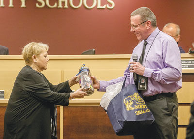  Kment Elementary School Principal Donovan Stec, right, presents school board President Theresa Genest with a jar of hearts with sentiments of thanks from the school’s teachers and students last year. 