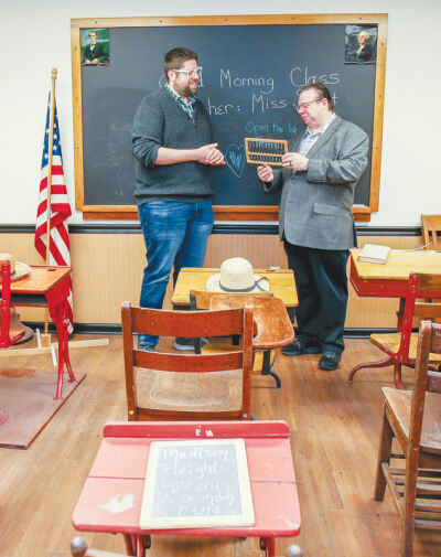  Mark Bliss, the mayor pro tem of Madison Heights, and Sean Fleming, a council member, help sort a reproduction  of a vintage classroom at the Heritage Rooms, a historical museum in the lower level of Madison Heights City Hall.  Bliss and Fleming serve on the Historical Commission.  