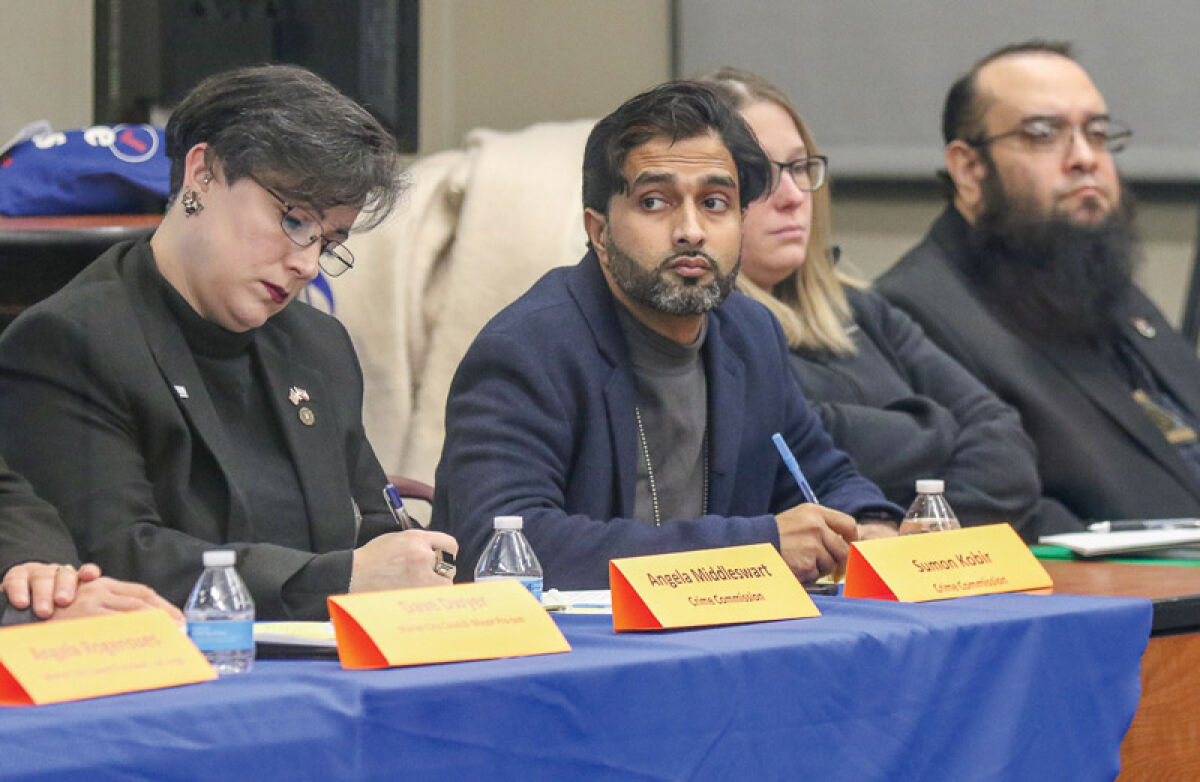  Crime Commission members Angela Middleswart, Sumon Kobir, Kayla Porvaznik, and Najim Ahmed listen as Warren residents express their concerns about public safety at the second stop of Warren Mayor Lori Stone’s “listening tour” at Lincoln High School on Jan. 22.  