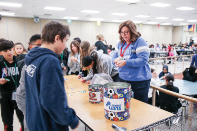  Grissom Middle School Principal Elizabeth Iljkoski, right, directs students to vote for their winning team during a lunchtime tailgate party. 