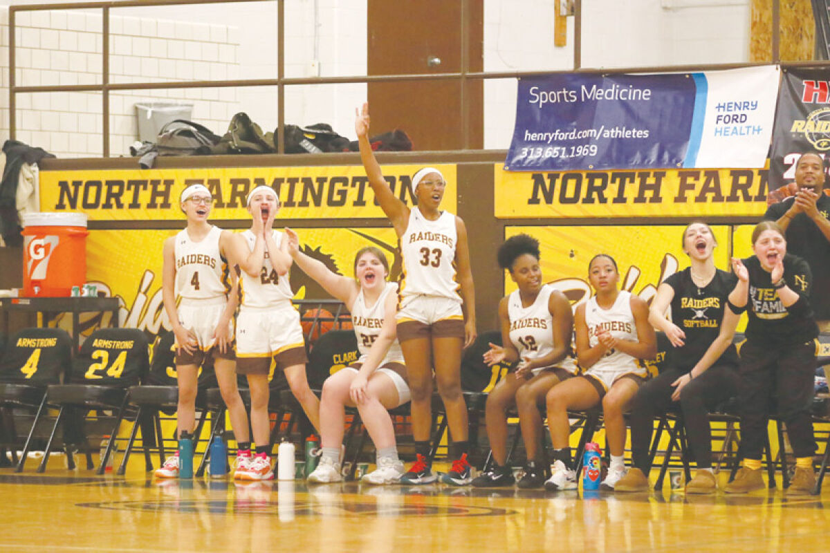  The North Farmington bench cheers on their team during a matchup against Bloomfield Hills High School on Jan. 30 at North Farmington High School. 