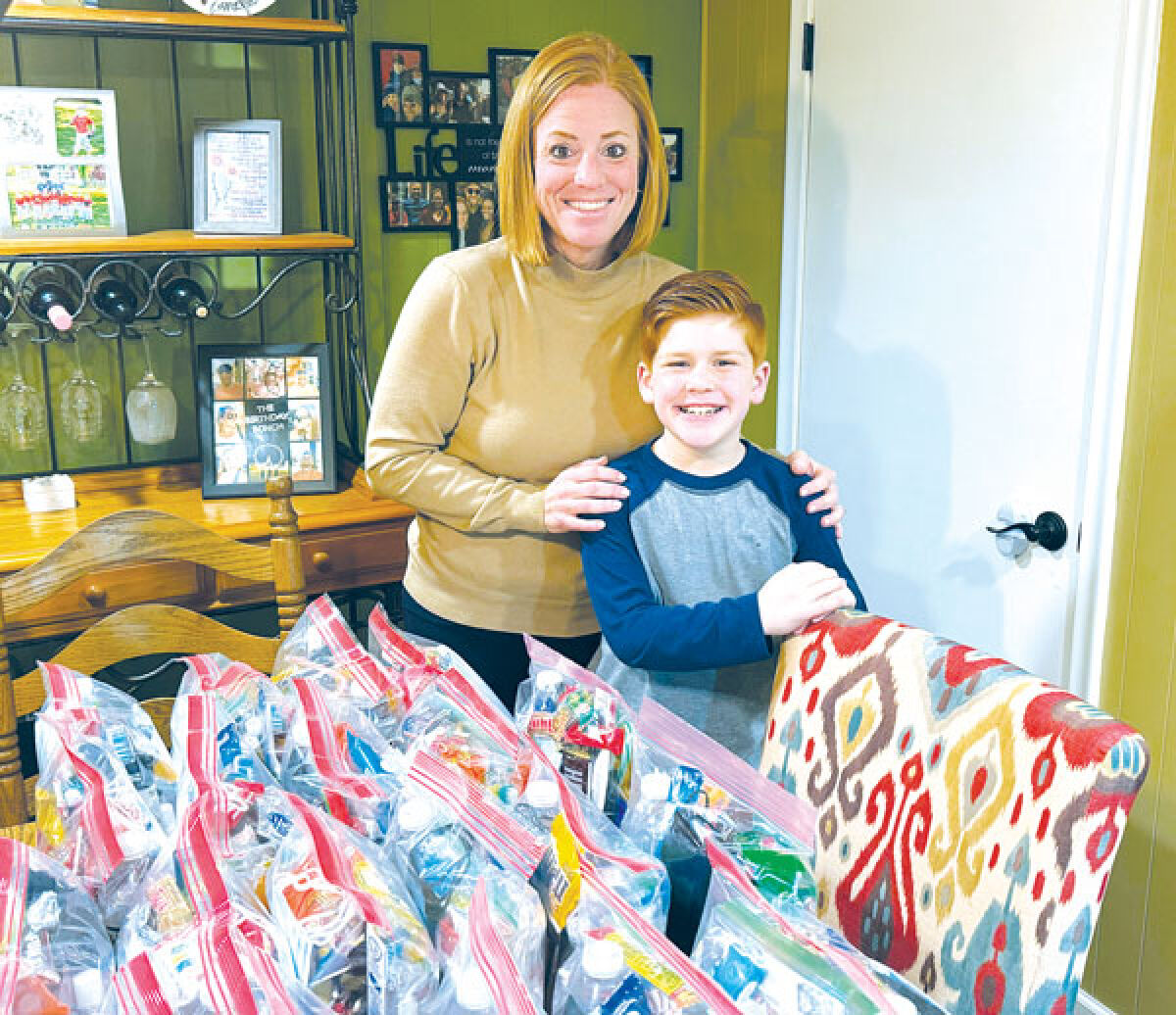  Shannon Verhelle and son Duncan Verhelle, 8, distribute bags of hope filled with everyday things and words of encouragement for those in need. 