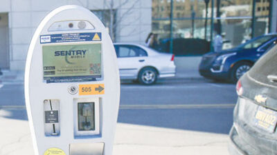  Sentry parking meters can be paid using the Sentry Mobile app or paid using coins, as seen on this Sentry parking meter on Center Street. 