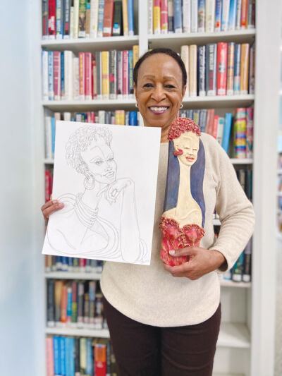  Princi Graham poses with her work at the Franklin Public Library.  