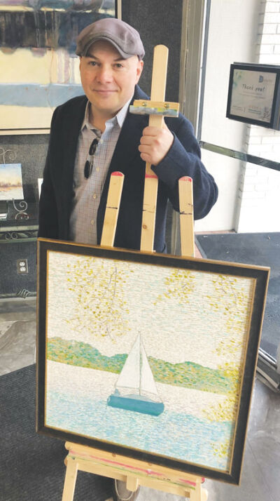  Artist William Schippert stands behind his painting, “Wind on Water.” 