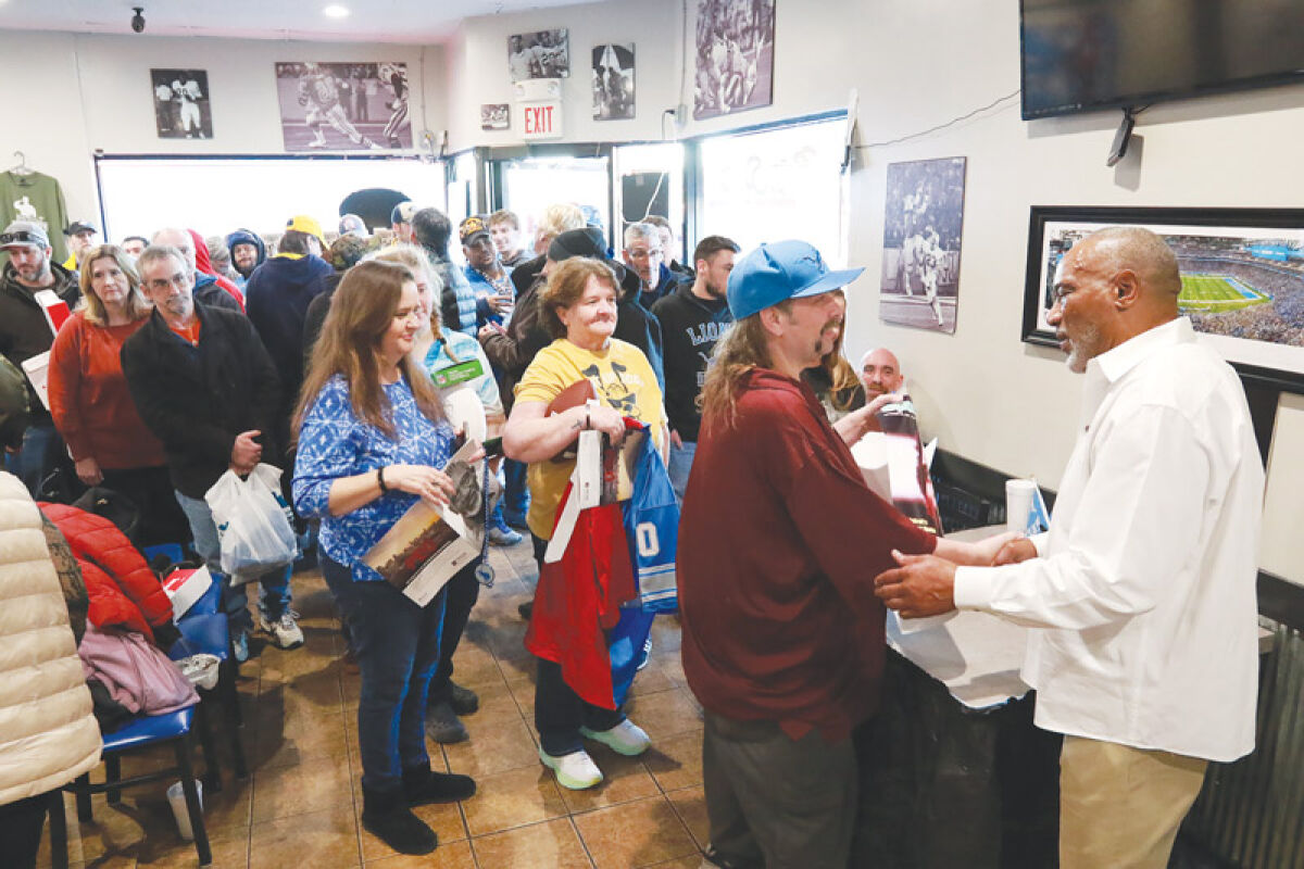  Detroit Lions fans wait patiently to meet legendary running back Billy Sims on Feb. 3 at a meet-and-greet event at his restaurant, Billy Sims Barbecue, in Troy. 