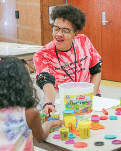  On Aug. 1, Lincoln High School senior Reginald Noble helps students in a STEM (science, technology, engineering and math) class. 