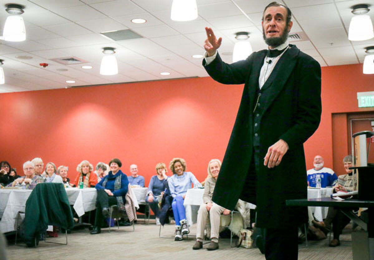  Kevin Wood, of Adrian, performs as Abraham Lincoln in front of a crowd of nearly 100 people at the Novi Public Library Feb. 1. 