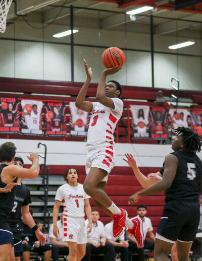  Roseville sophomore guard Jadarius Payne attempts a floater during a matchup against Sterling Heights Stevenson Jan. 26 at Roseville High School. 