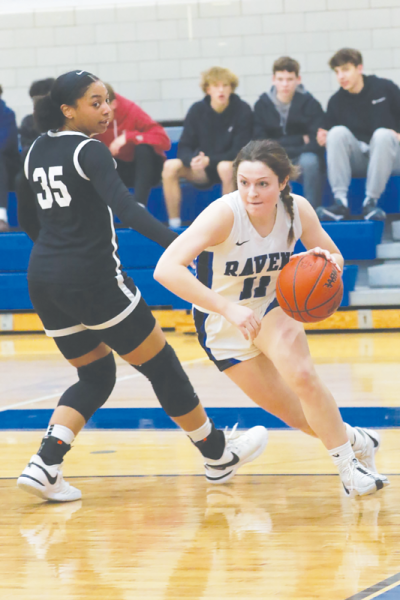  Royal Oak junior guard Maddie Lawrence drives past a  Bloomfield Hills defender as the two teams square off Feb. 16 at  Royal Oak High School.  