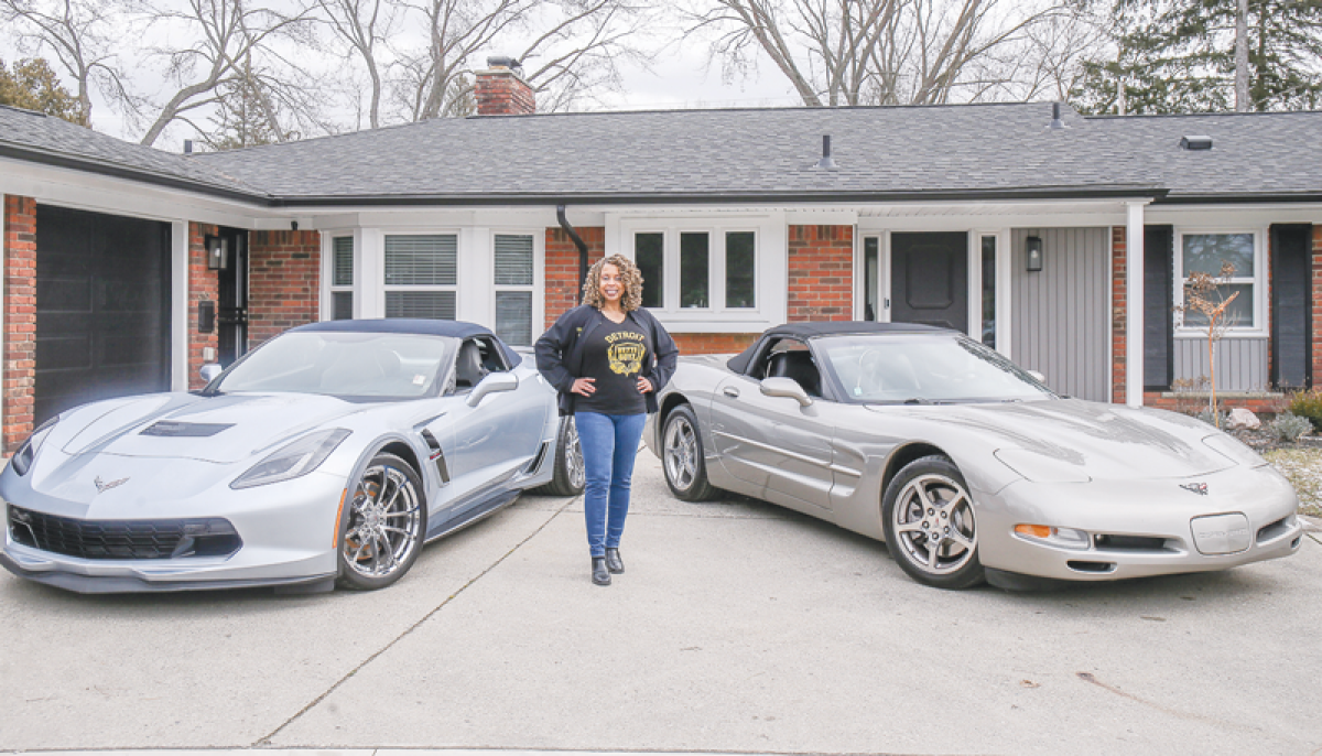  Charlotte “Goldie” Davidson poses with her two Corvettes, a 2017 on the  left and a 2002 on the right.   