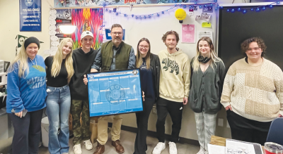  Eric Flessa, from Troy College and Career High School, stands with several of the students who nominated him as the Troy School District’s 2024 High School Teacher of the Year.  
