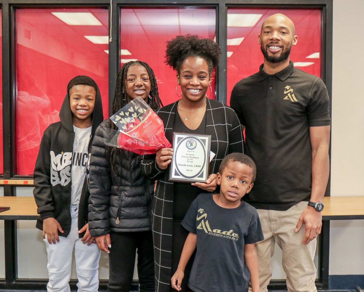  Danielle Lewis’ family attends the presentation of her Macomb County School Social Worker of the Year award Feb. 16. From left are Darius Jr., 12; Darielle 13; Lewis; Daniel, 5; and husband Darius. 