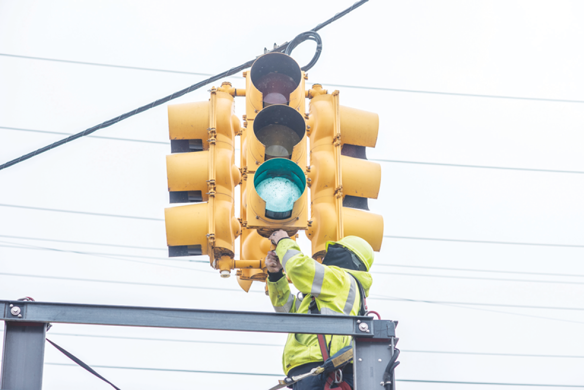  A Macomb County Department of Roads worker installs JVIS-made heaters on a traffic signal light in November 2023. 