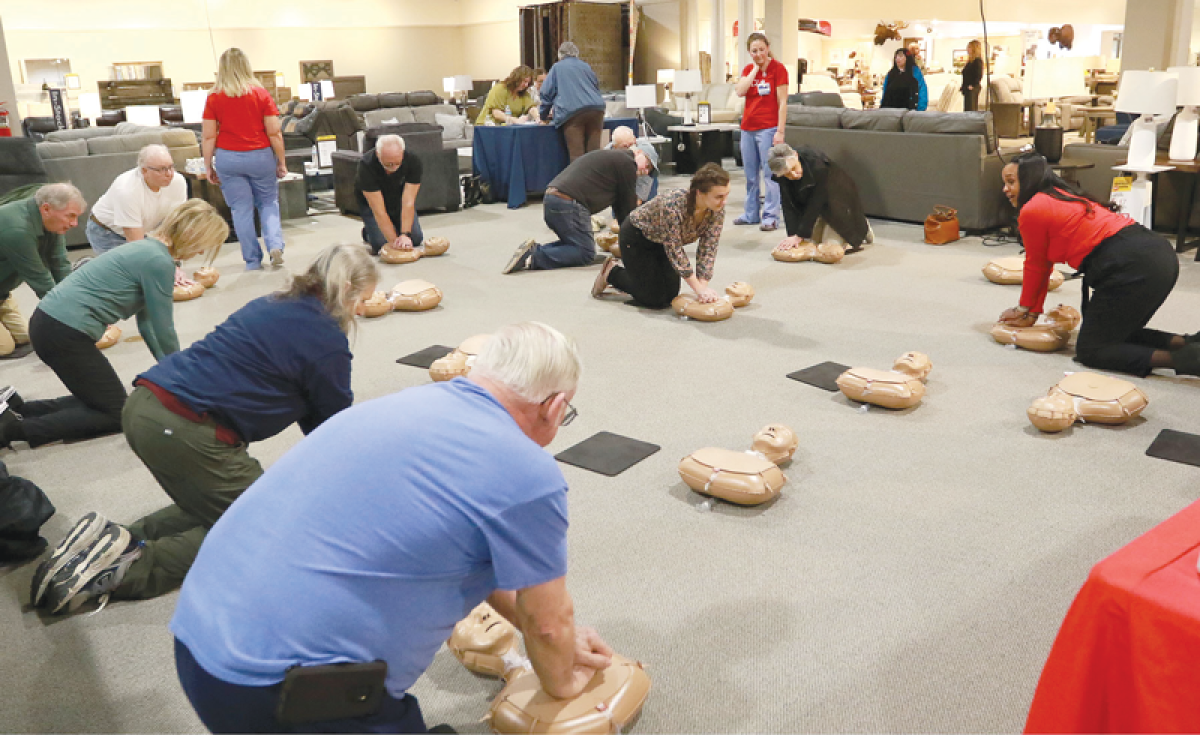   Mallory Applewhite, vice president of community impact with the American Heart Association in Michigan, leads a free hands-only CPR training session at Gardner White in Shelby Township Feb. 22.  
