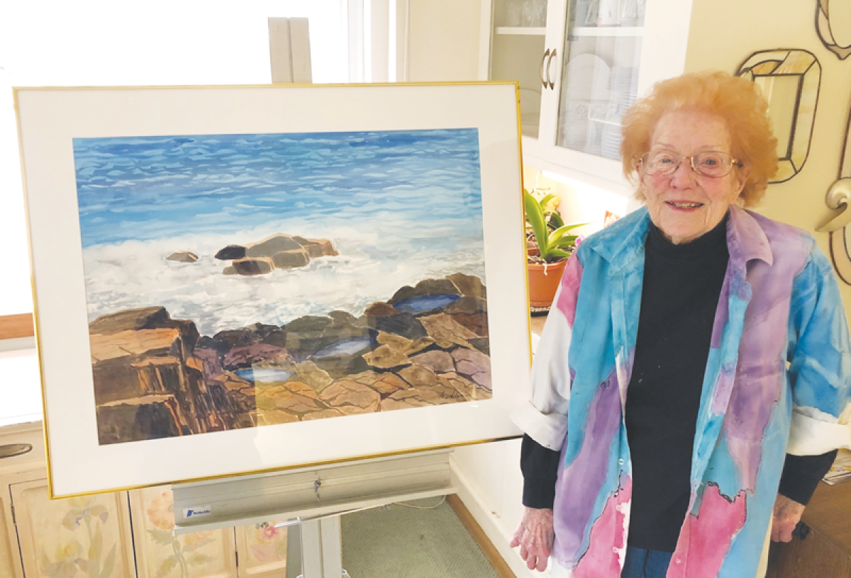  Grosse Pointe Woods artist Bette Prudden stands next to one of her moving water paintings, “Maine View.” 