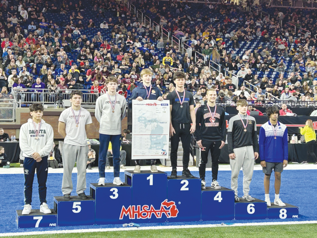  Grosse Pointe South junior Wyatt Hepner stands at the top of the MHSAA podium after winning the MHSAA Division 1 individual state championship in the 138-pound weight class on March 2 at Ford Field. 