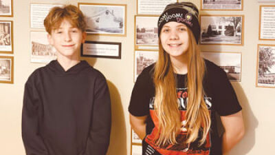  Owen Ball and Marlayna Reinhardt have fun digitizing newspaper clippings for the Clawson Historical Museum Feb. 24. 