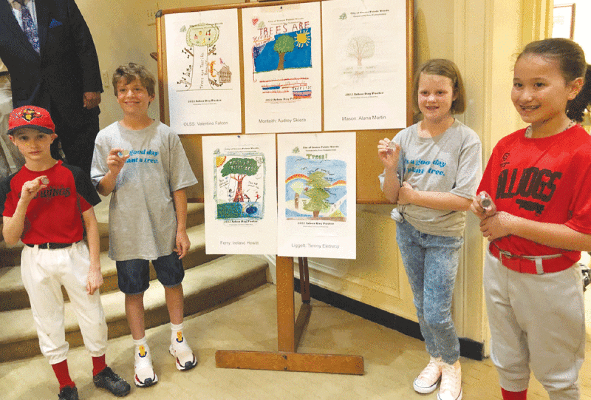  From left, Valentino Falcon, of Our Lady Star of the Sea Catholic School; Timmy Eletreby, of University Liggett School; Audrey Skiera, of Monteith Elementary School; and Ireland Hewitt, of Ferry Elementary School, flank their award-winning posters for Grosse Pointe Woods’ annual Arbor Day poster contest. The students were honored during a June 6 City Council meeting. 