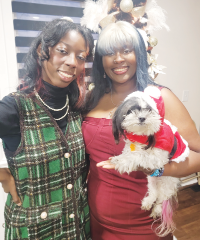  Sisters and current college students Daviona and Davonna Burton hold Lala, the family’s Shih Tzu they had since 2012. 