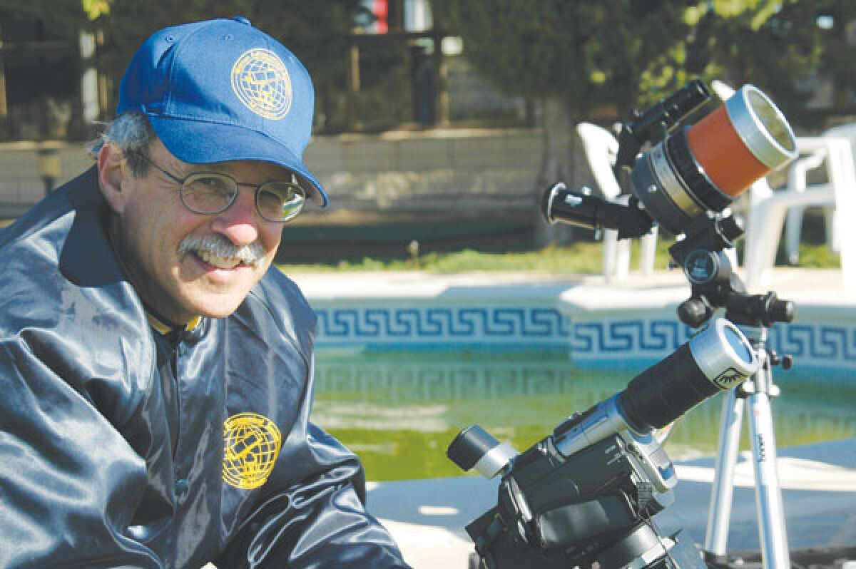  Ken Bertin poses with his telescope he uses to view solar eclipses. He is 77 years old and has loved astronomy since he was 6. 