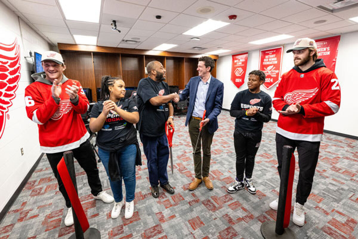  Detroit Red Wings teammates Christian Fischer, far left, and Michael Rasmussen, far right, help officially open the new Esports & Gaming Lounge at the Boys & Girls Club in Eastpointe Feb. 29. 