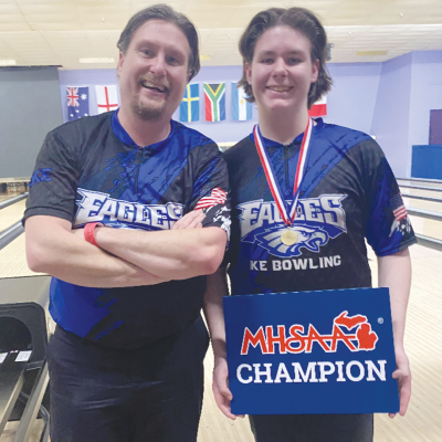  Utica Eisenhower junior Dylan Harnden and his father, Mark Harnden, Eisenhower boys bowling head coach, celebrate Dylan’s MHSAA Division 1 individual state title March 2 at Thunderbowl Lanes in Allen Park. 