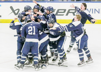  Bloomfield Hills Cranbrook Kingswood celebrates after junior defenseman David Schmitt fired home the game-winning goal 3:34 into the third overtime, giving the Cranes the 3-2 Division 3 state championship win. 