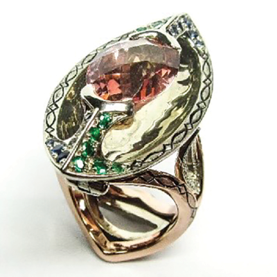 Link Wachler’s piece, “Valhalla,” is an imperial topaz ring that converts to a pendant. It is made of white gold, rose gold, sapphires, diamonds and emeralds.  