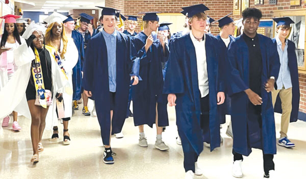  Several families at Fraser High School have objected to the decision by the district to change the former graduation gown colors from white for girls and blue for boys to a uniform blue and yellow design. 