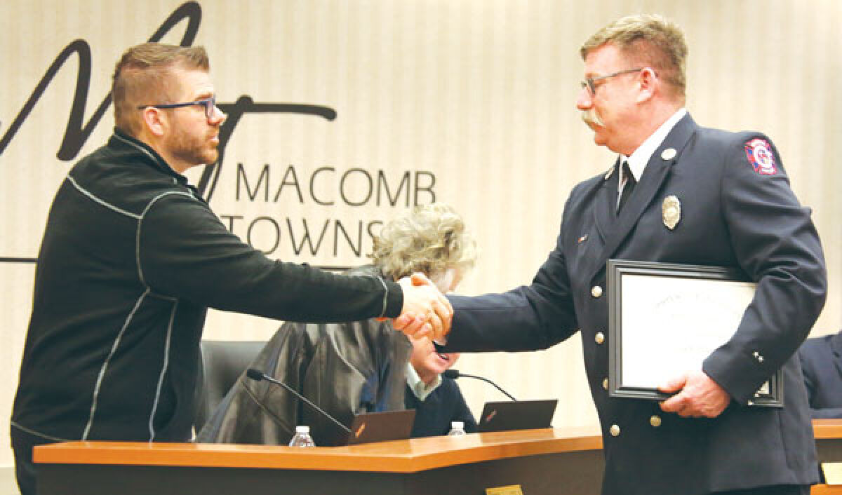  Macomb Township Trustee Peter Lucido III, left, shakes hands with Sgt. James Peterson, of the Macomb Township Fire Department. Peterson is the first Macomb Township firefighter to complete the National Fire Academy’s Managing Officer Program. 
