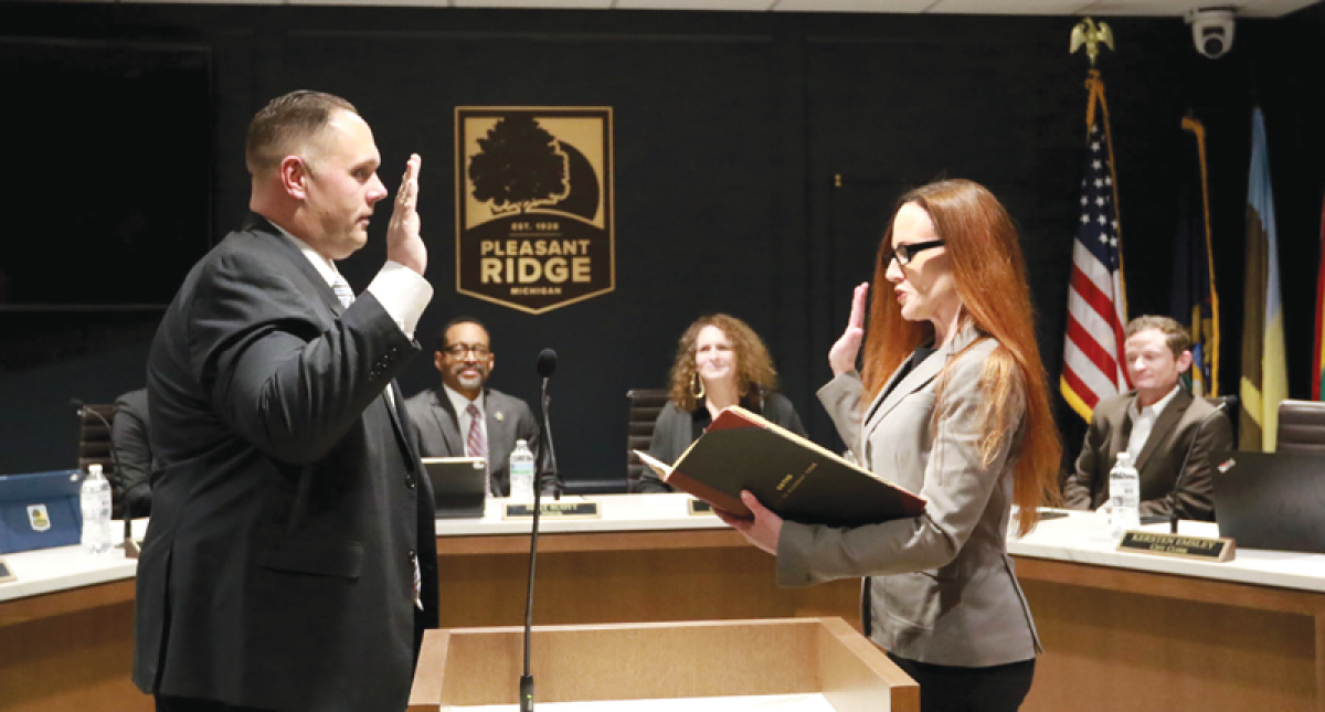  Robert Ried takes the oath of office from City Clerk Kersten Emsley to become the next police chief in Pleasant Ridge at the March 12 City Commission meeting. 