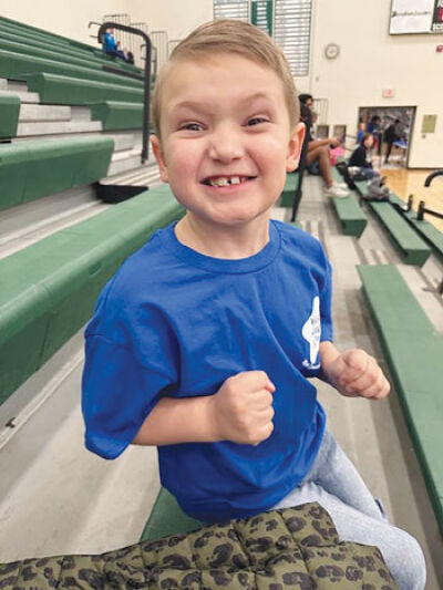  Charlie Trammell sits in the bleachers during the students vs. staff basketball game at Novi High School March 15. He will go to Disney World in May thanks to the efforts of the Novi Community School District and the Make-A-Wish Foundation. 