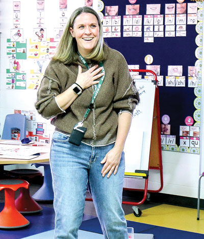  Heather Stewart, a kindergarten teacher at Deerfield Elementary School in Novi, finds out March 18 that she is the district’s Educator of the Year as her family, school officials, colleagues and members of the media enter her classroom. 