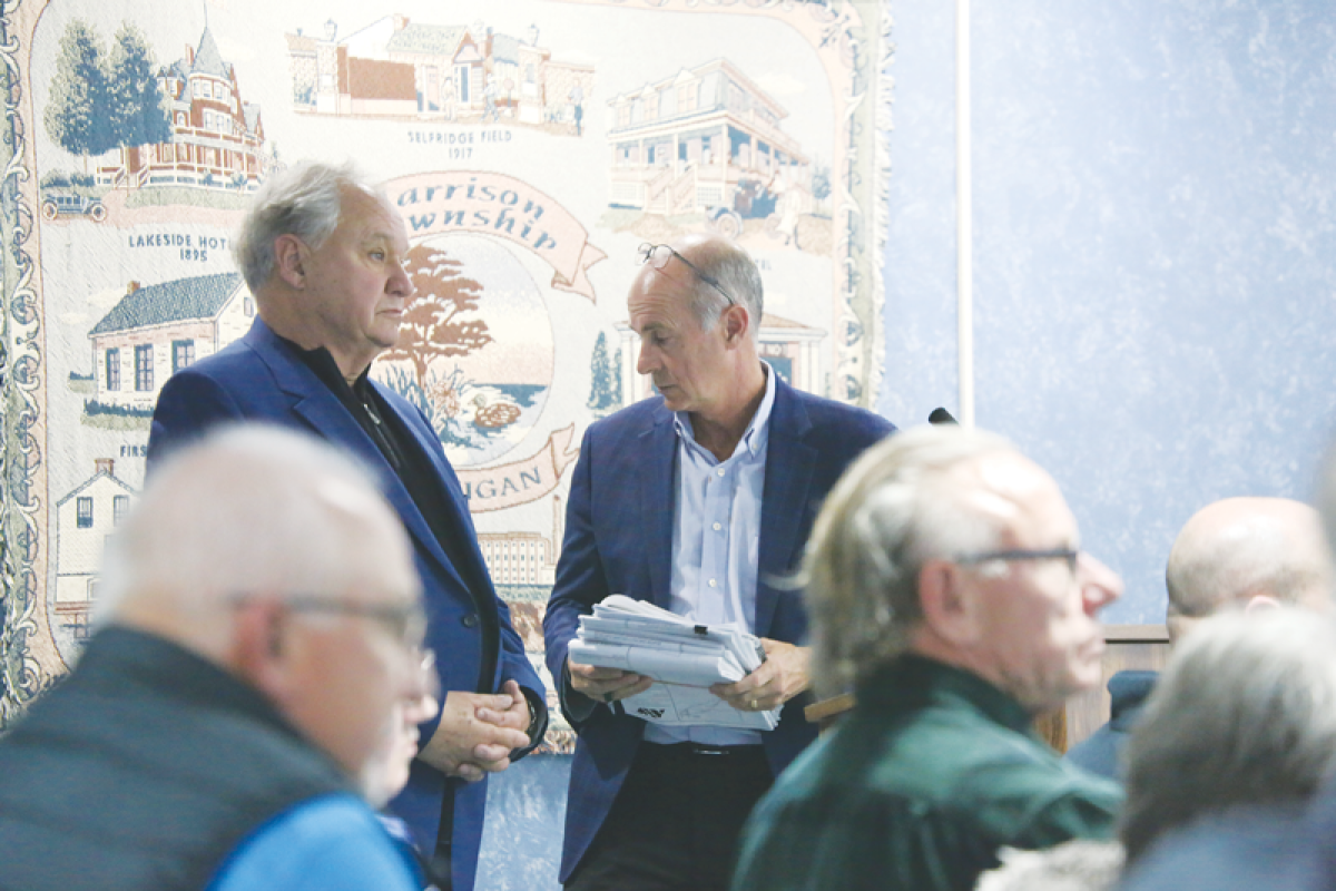  Randy DePrez, partner with Victoria Park Holdings, LLC (left), and Stephen Pangori, president and CEO of engineering firm Anderson, Eckstein & Westrick, appear before the Harrison Township Planning Commission in support of an 82-unit site condo proposal on March 21.   