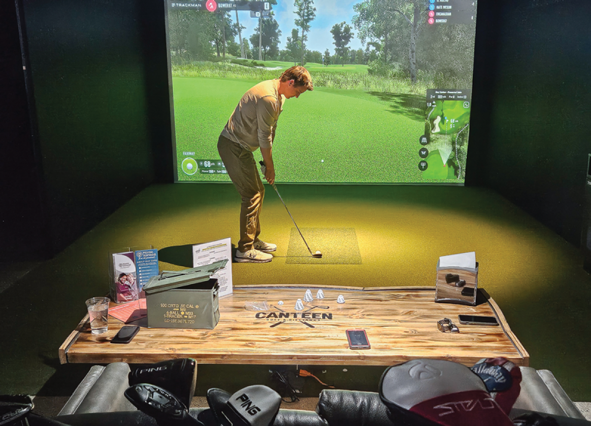  Dylan Kolito, of Clinton Township,  sets up for a shot at the golf simulator at Canteen Golf and Billiards in Clinton Township during  its soft opening on March 21. 
