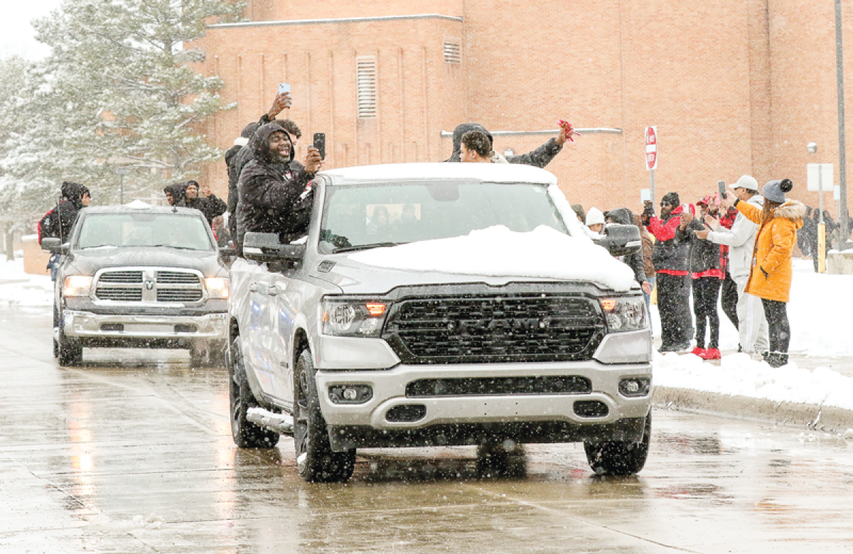  Warren Lincoln players and coaches celebrate their Michigan High School Athletic Association Division 2 state championship win with a parade around the school on March 22. 