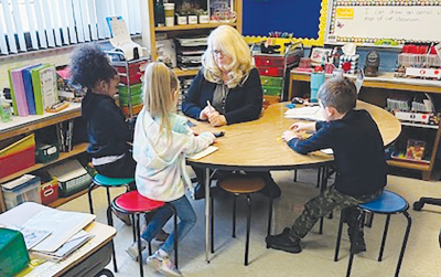  Roose Elementary School’s “outstanding” first grade teacher Kristin Henninger works with a group of  students in class.  