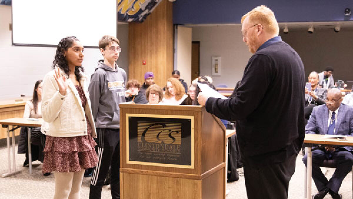  Clintondale Community Schools Board of Education President Jared Maynard, right, swears in Abriana Guzman, left, and Kurt Violet at the board’s meeting on March 18. 